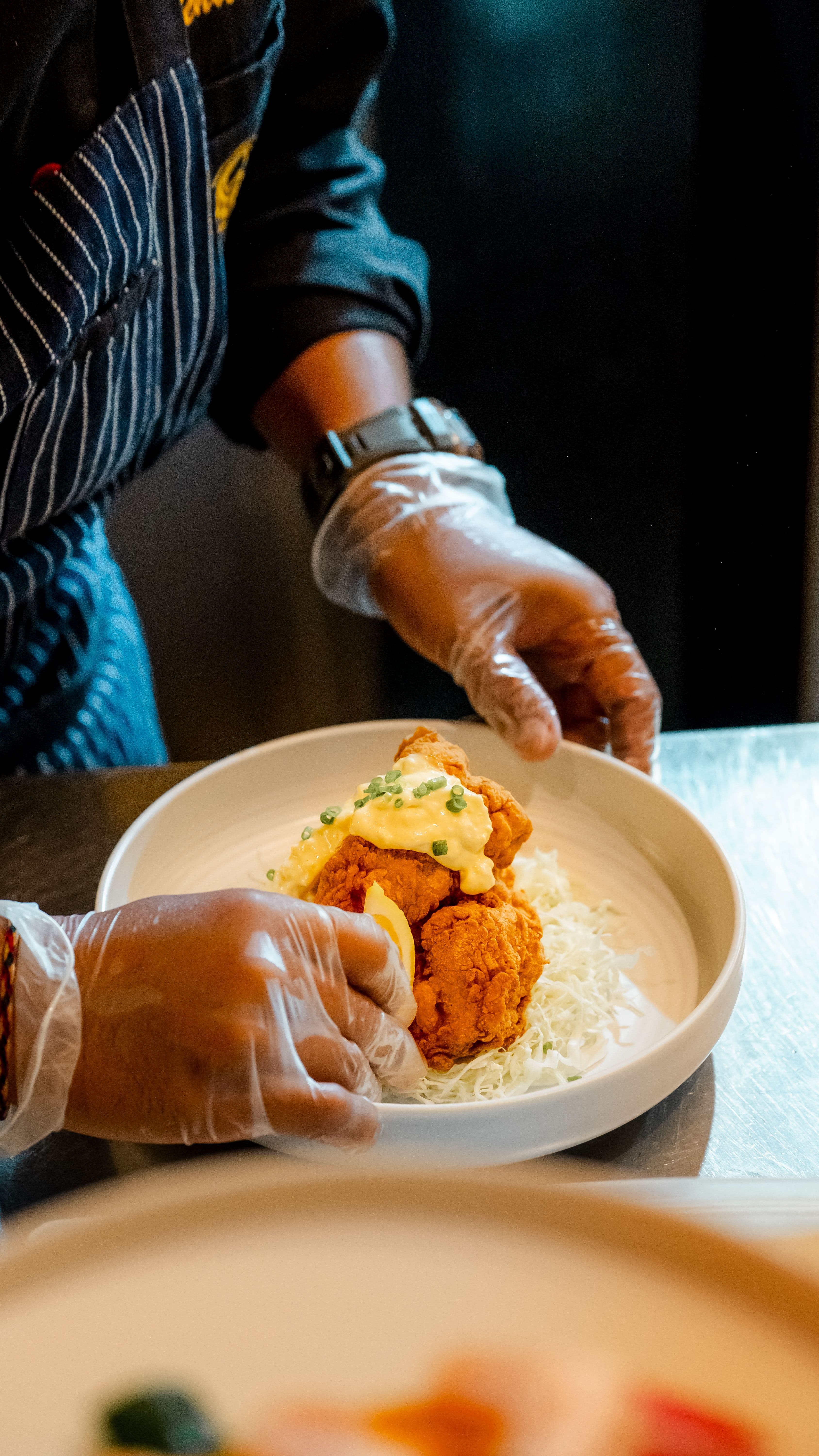 Chef setting fried chicken plate